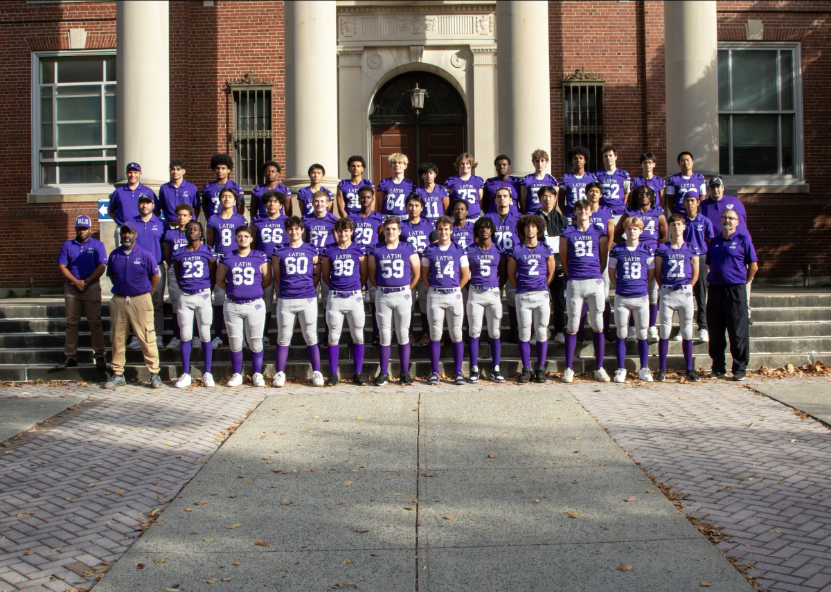 Athletes and coaches of the BLS varsity football team line up before a game.
(Source: Christian Le (I))